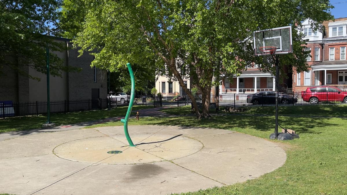 The splash pad area at Audrey Carey Park with a makeshift basketball hoop set up by kids.