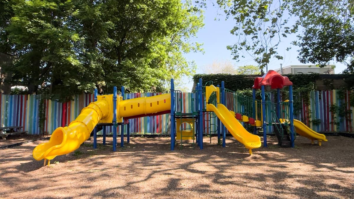 The main yellow and blue play structure at Hasbrouck Street Park.