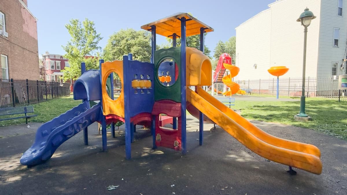 A small toddler play structure at Xavier Lunan Park under shade.